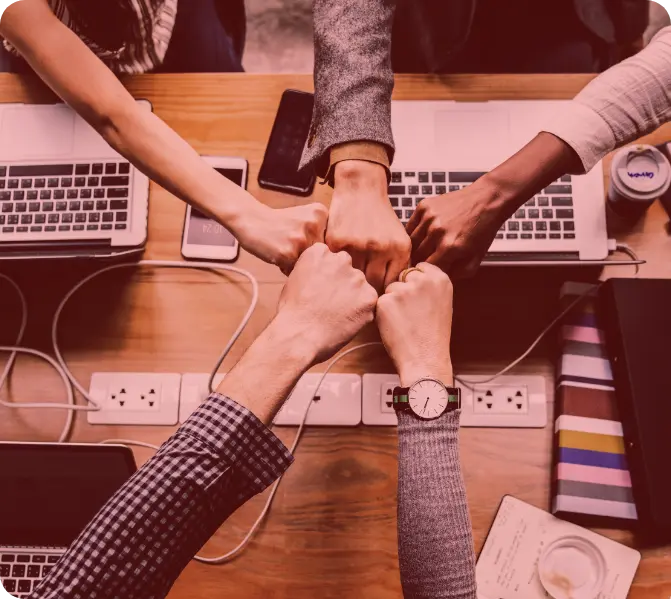 A group of people sitting around a table in a meeting room.