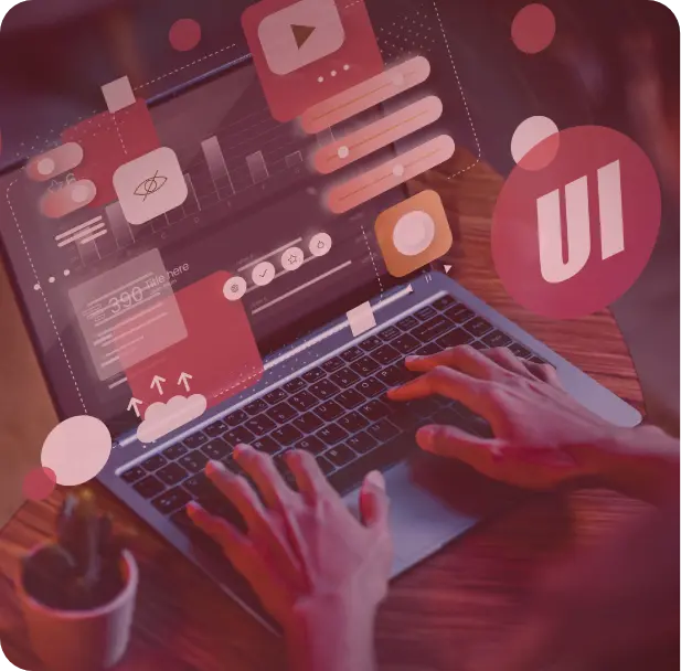A group of people sitting around a table working on a laptop.