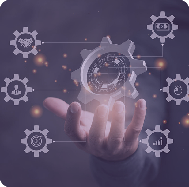 A group of people sitting around a table working on a laptop.