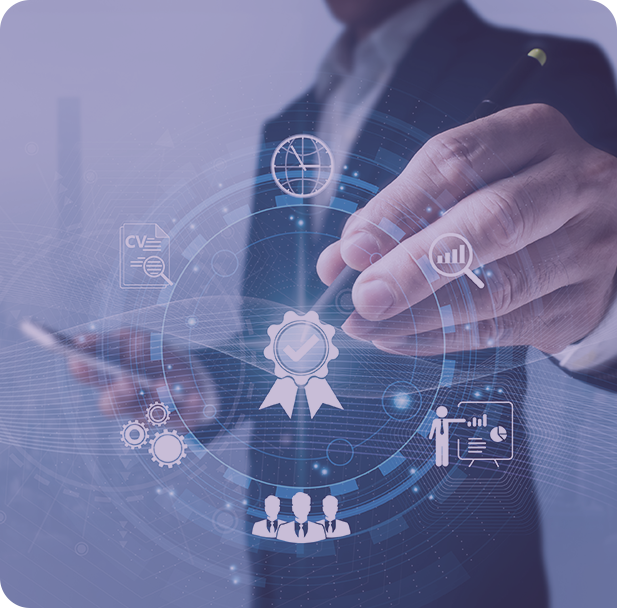 A group of people sitting around a table working on a laptop.